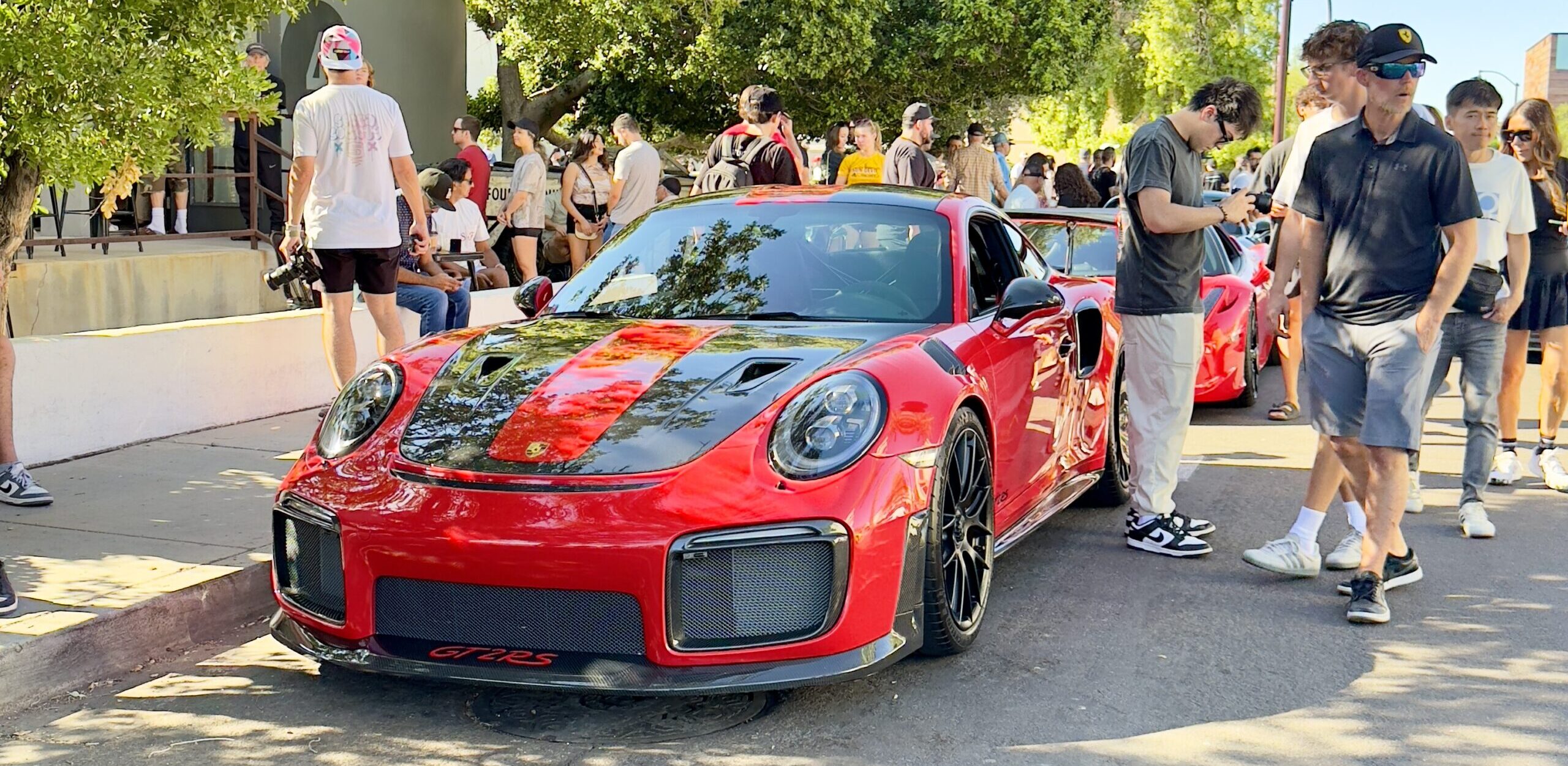 Porsche parked in front of a crowd at Fourtillfour Porsches + Coffee event in Old Town Scottsdale