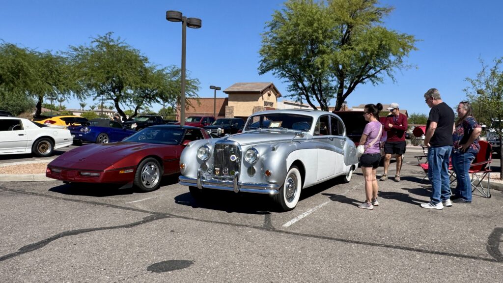 Classic silver and white Jaguar at a car show in front of Ruggiero’s Ace Hardware Cars and Coffee car show in Queen Creek, AZ.