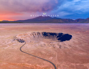 Meteor Crater: Welcome to Arizona—aerial of Barringer Meteor Crater with road and visitor center under a colorful sky.