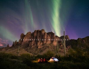Superstition Mountains: Welcome to Arizona—campers and a tent beneath aurora-like lights over the Superstition Mountains with saguaros.
