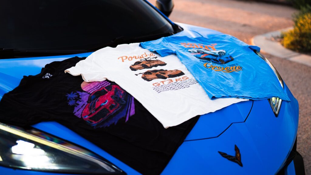 Spec Apex Corvette with car inspired apparel on hood.